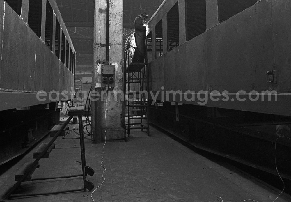 GDR photo archive: Halberstadt - Maintenance and repair work in the Bw railway depot of the Deutsche Reichsbahn on reconstruction express train cars in Halberstadt in the state Saxony-Anhalt on the territory of the former GDR, German Democratic Republic