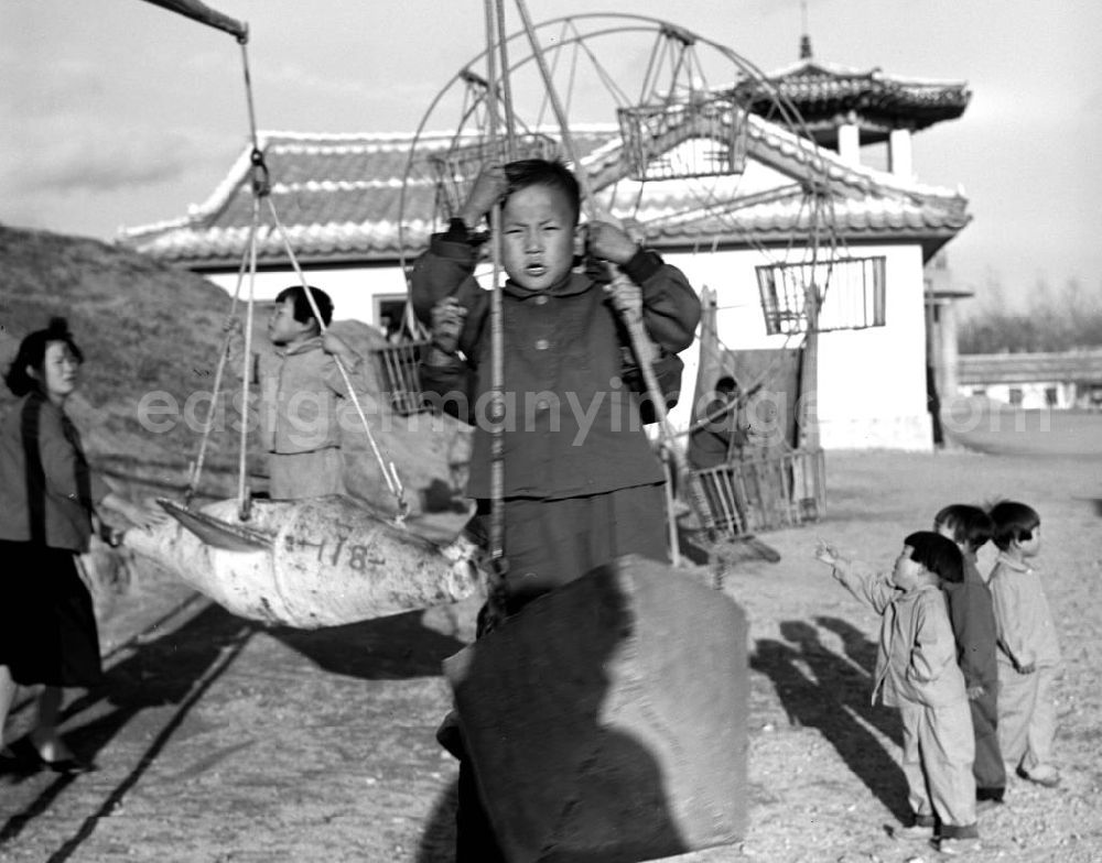 GDR photo archive: Hamhung - Kinder in Einheitsanzügen spielen auf einem Spielplatz in einem LPG-Kindergarten nahe der Hafenstadt Hamhung in der Koreanischen Demokratischen Volksrepublik KDVR - Nordkorea / Democratic People's Republic of Korea DPRK - North Korea.