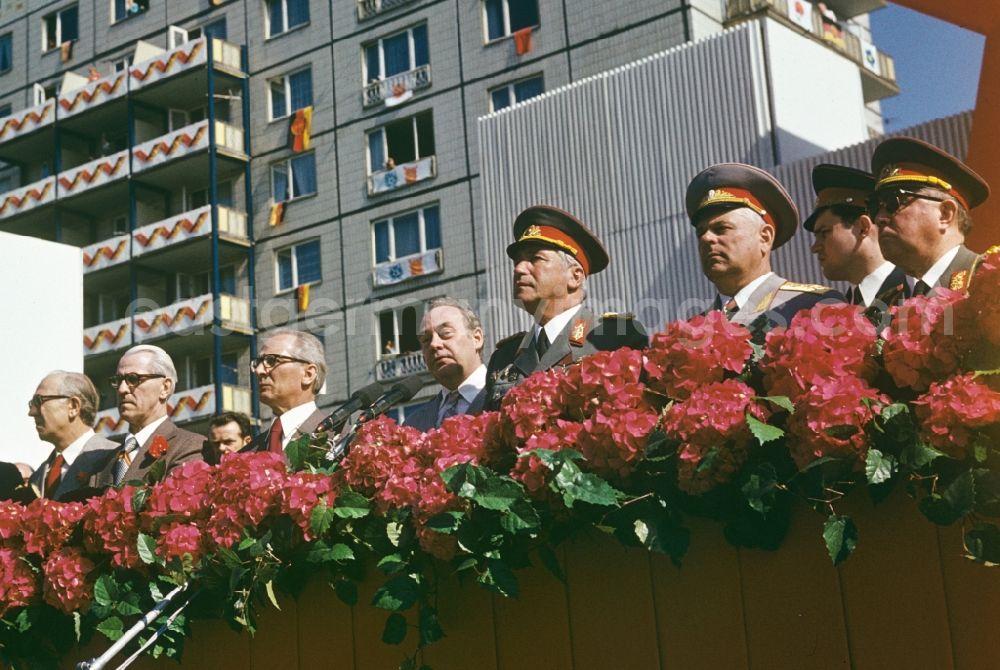 GDR picture archive: Berlin - Officials on the tribune at Karl-Marx-Allee during the parade for 1 May, the struggle and holiday of the labourers in the district Mitte in Berlin, the former capital of the GDR, German Democratic Republic. Leading politicians and military officers of the GDR from left: Horst Sindermann, Willi Stoph, Erich Honecker, Harry Tisch, Heinz Hoffmann, Soviet general, Erich Mielke