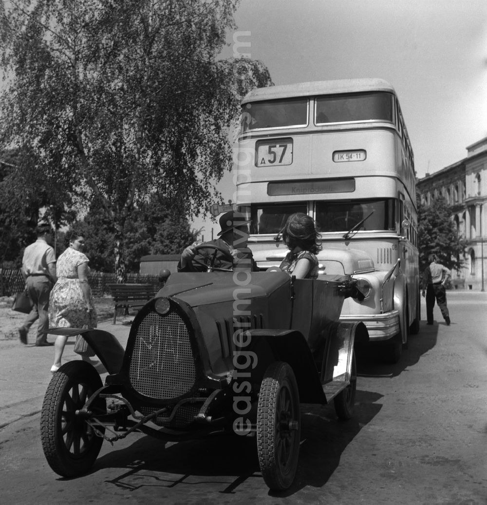 Berlin: Vintage F5 from the automobile manufacturer MAF stands in front of a double-decker bus line 57 in East Berlin in the area of the former GDR, German Democratic Republic