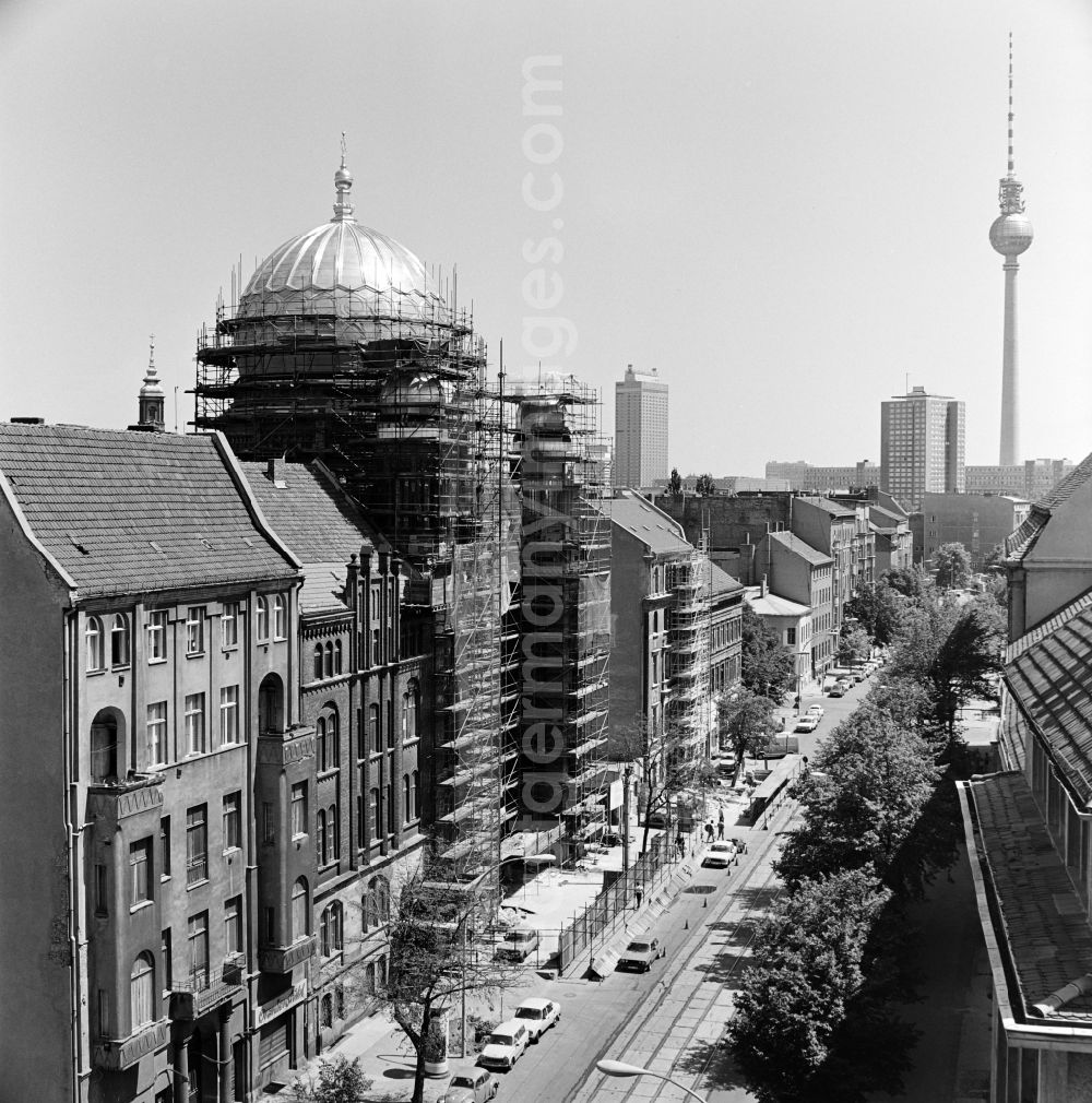 GDR picture archive: Berlin - View of the Oranienburger Strasse towards the city center with New Synagogue during the construction works and TV tower in the background in Berlin - Mitte, the former capital of the GDR, German Democratic Republic