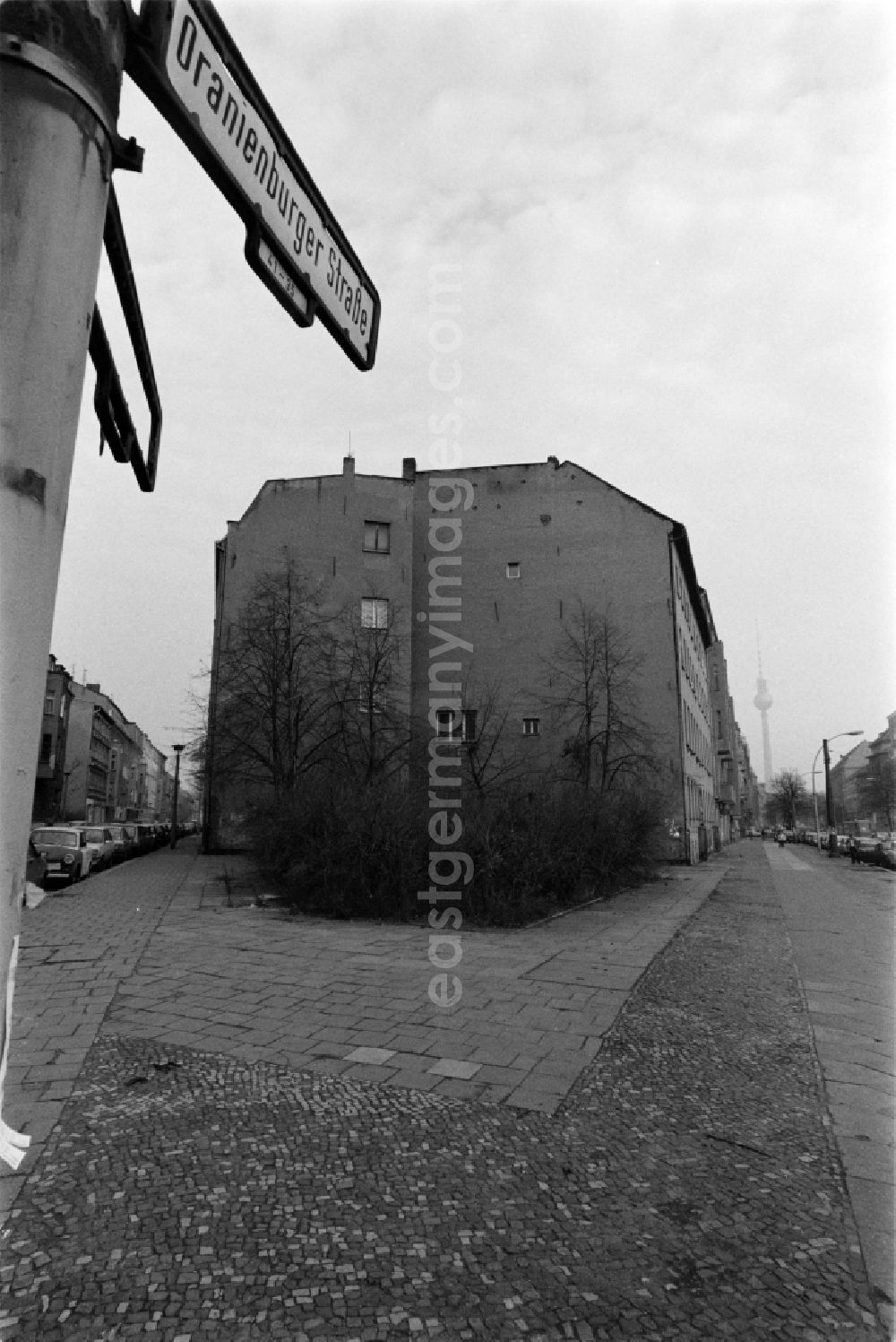 GDR photo archive: Berlin - Oranienburger Strasse on the corner Auguststrasse with view towards the city center on the TV tower in Berlin - Mitte, the former capital of the GDR, German Democratic Republic