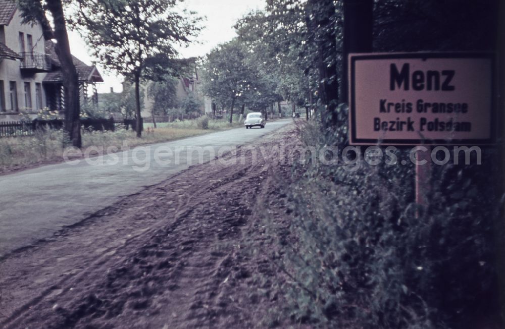 Menz: Town entrance sign placed on the side of the road on street Fuerstenberger Strasse in Menz, Brandenburg on the territory of the former GDR, German Democratic Republic