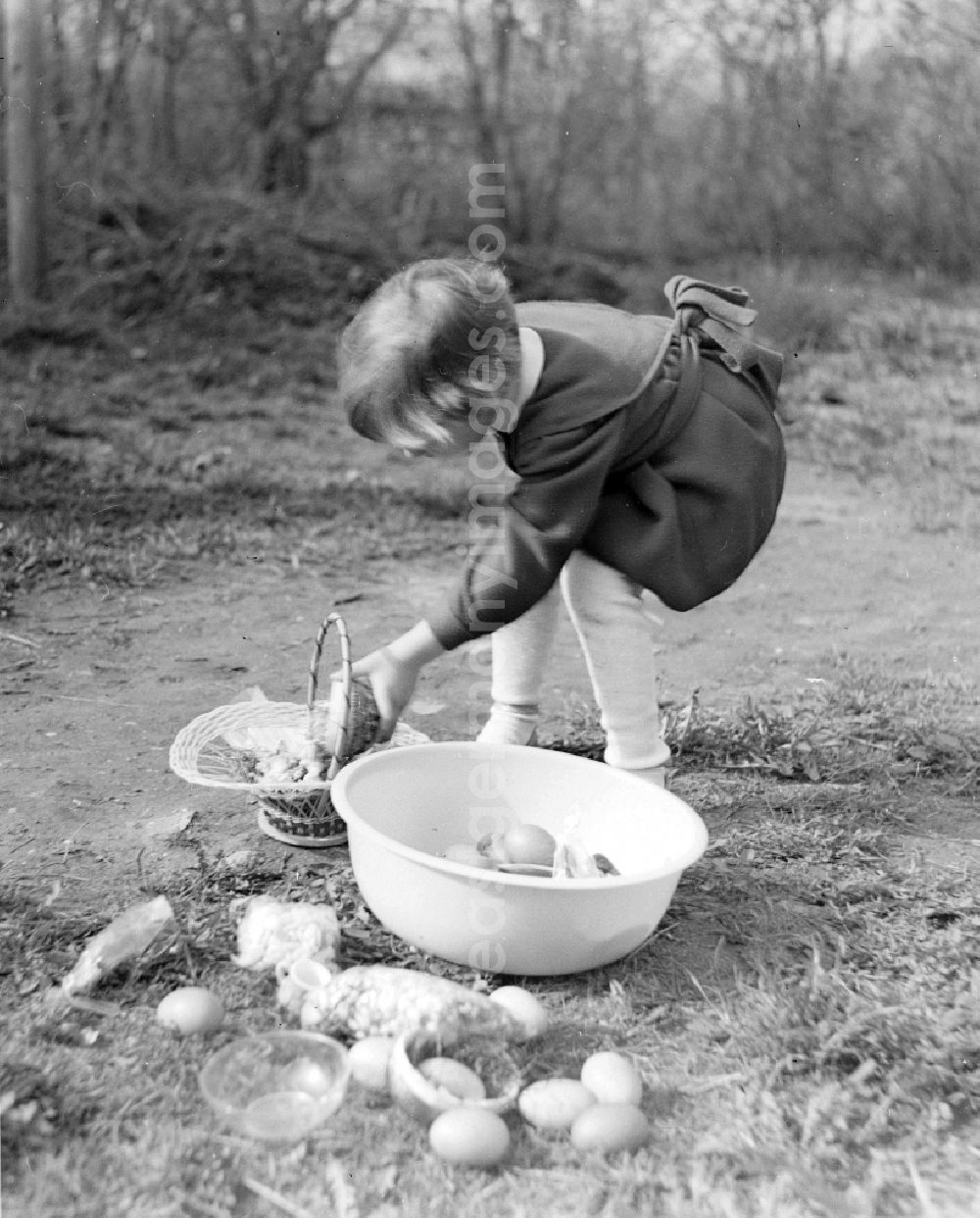 GDR image archive: Zschopau - A small child in a dress with the Easter egg look in the garden in Zschopau in the federal state Saxony in the area of the former GDR, German democratic republic