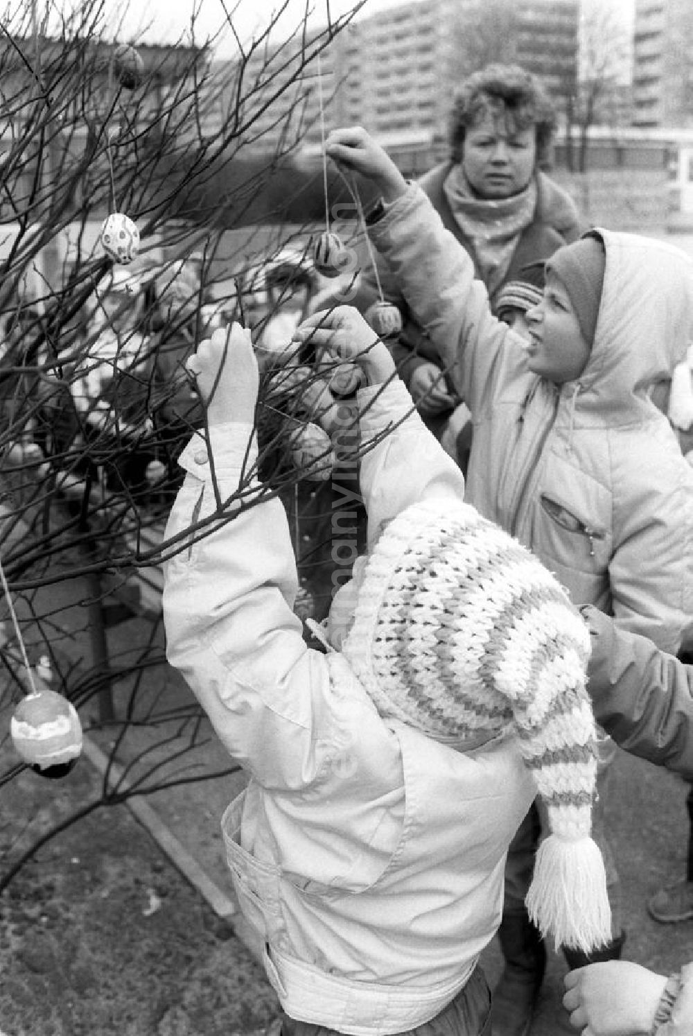 GDR photo archive: Berlin - Die Kleinen aus dem Kindergarten in der Rudolf-Seiffert-Straße in Berlin-Lichtenberg schmücken einen Osterbaum mit selbst bemalten ausgeblasenen Eiern.