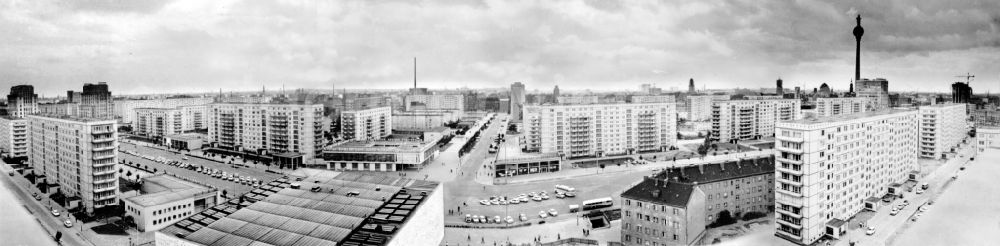 GDR photo archive: Berlin - Panorama of the Karl-Marx-Allee with the Cafe Moskau, residential or multi-family homes and the currently under construction TV tower in Berlin-Mitte. Bestmögliche Qualität nach Vorlage!