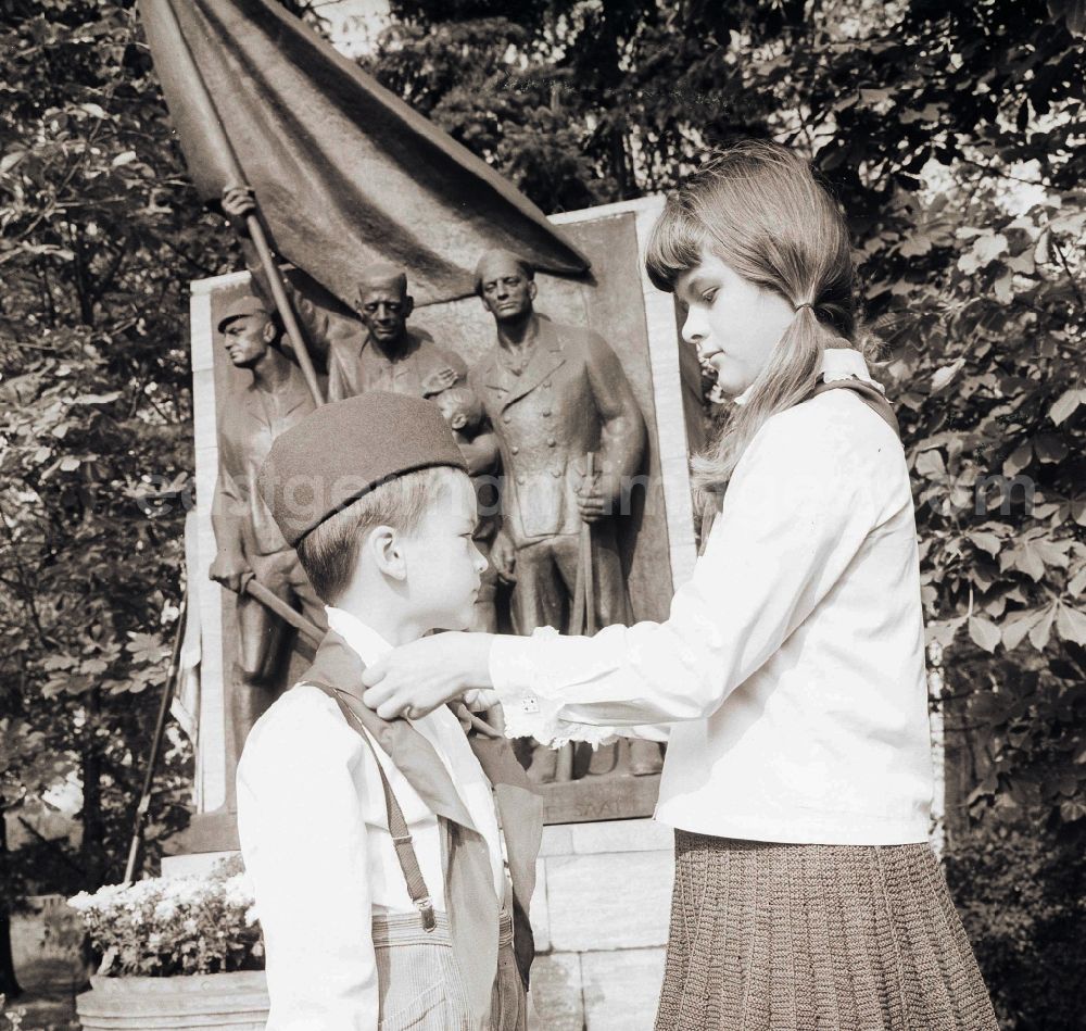 Berlin: A young's pioneer of the 1st class receives solemnly his blue neckerchief from Thaelmann pioneer hands in Berlin, the former capital of the GDR, German democratic republic