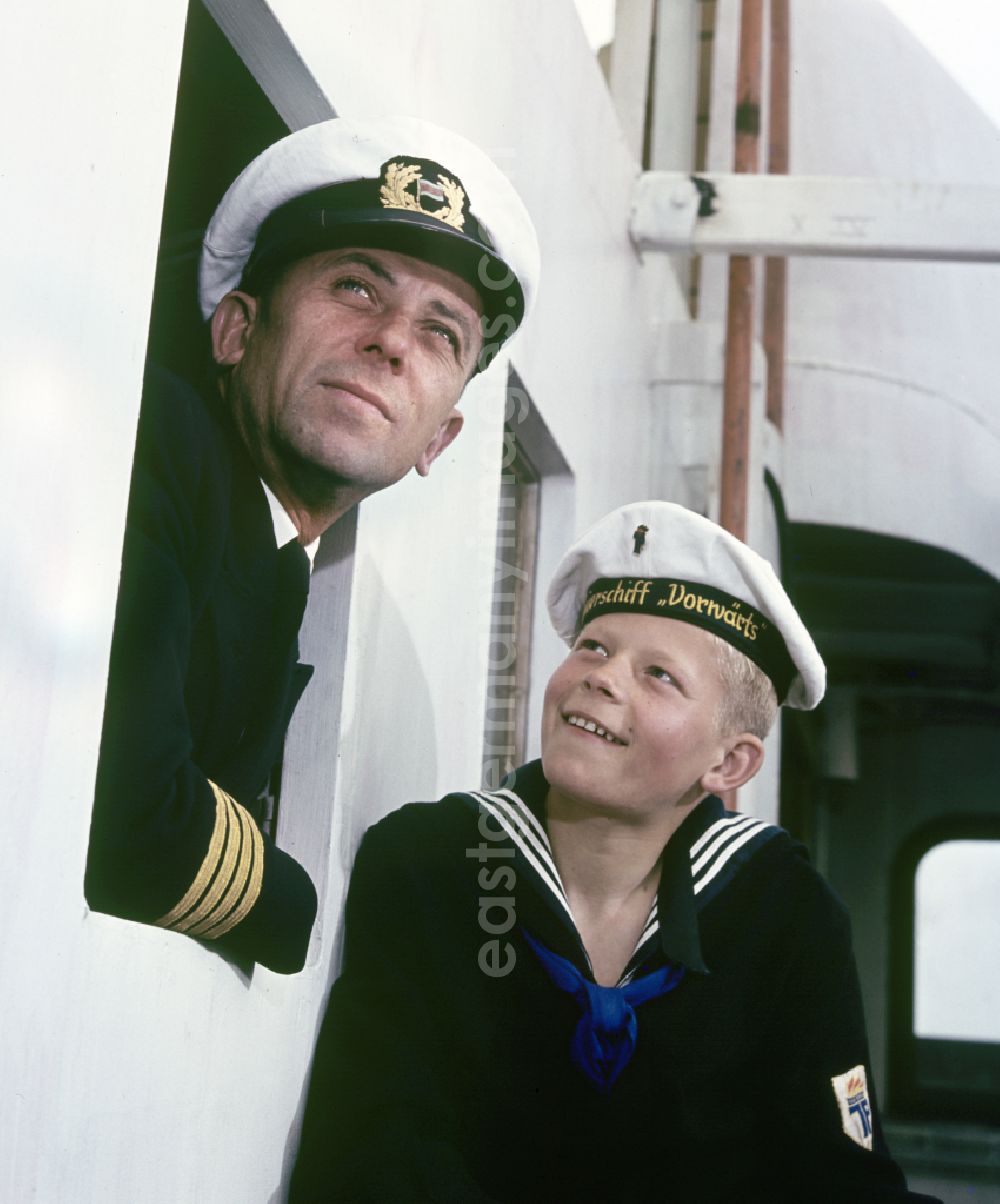 GDR picture archive: Rostock - A boy in sailor's uniform and a man in captain's uniform pose on the pioneer ship Vorwaerts in Rostock, Mecklenburg-Vorpommern in the territory of the former GDR, German Democratic Republic