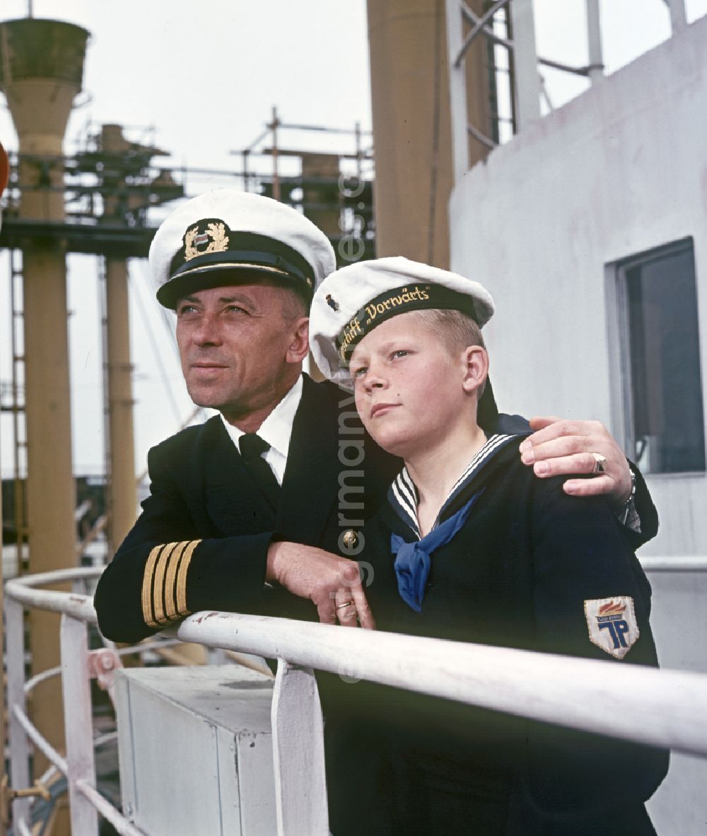 GDR image archive: Rostock - A boy in sailor's uniform and a man in captain's uniform pose on the pioneer ship Vorwaerts in Rostock, Mecklenburg-Vorpommern in the territory of the former GDR, German Democratic Republic