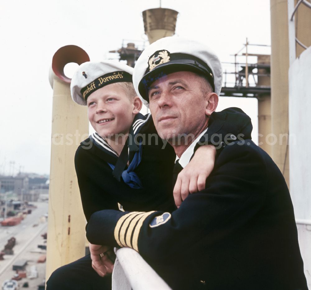 GDR picture archive: Rostock - A boy in sailor's uniform and a man in captain's uniform pose on the pioneer ship Vorwaerts in Rostock, Mecklenburg-Vorpommern in the territory of the former GDR, German Democratic Republic