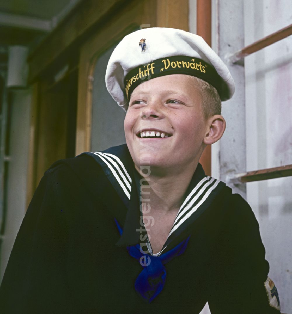 GDR image archive: Rostock - A boy in sailor's uniform pose on the pioneer ship Vorwaerts in Rostock, Mecklenburg-Vorpommern in the territory of the former GDR, German Democratic Republic