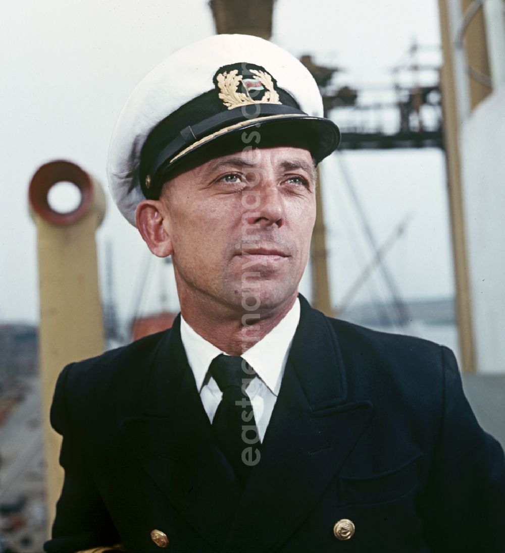 GDR photo archive: Rostock - A man in captain's uniform pose on the pioneer ship Vorwaerts in Rostock, Mecklenburg-Vorpommern in the territory of the former GDR, German Democratic Republic