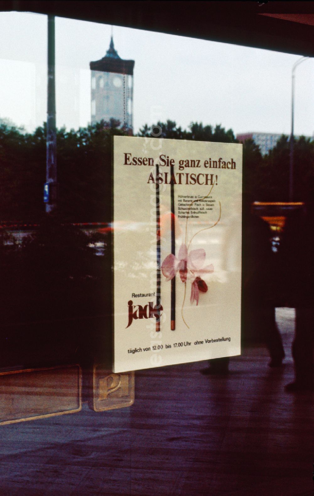 GDR picture archive: Berlin - Poster in a window of the Restaurant Jade in the Palace of the Republic in the Mitte district of Berlin in the territory of the former GDR, German Democratic Republic. Eat simply ASIAN ! is the advertisement on the poster