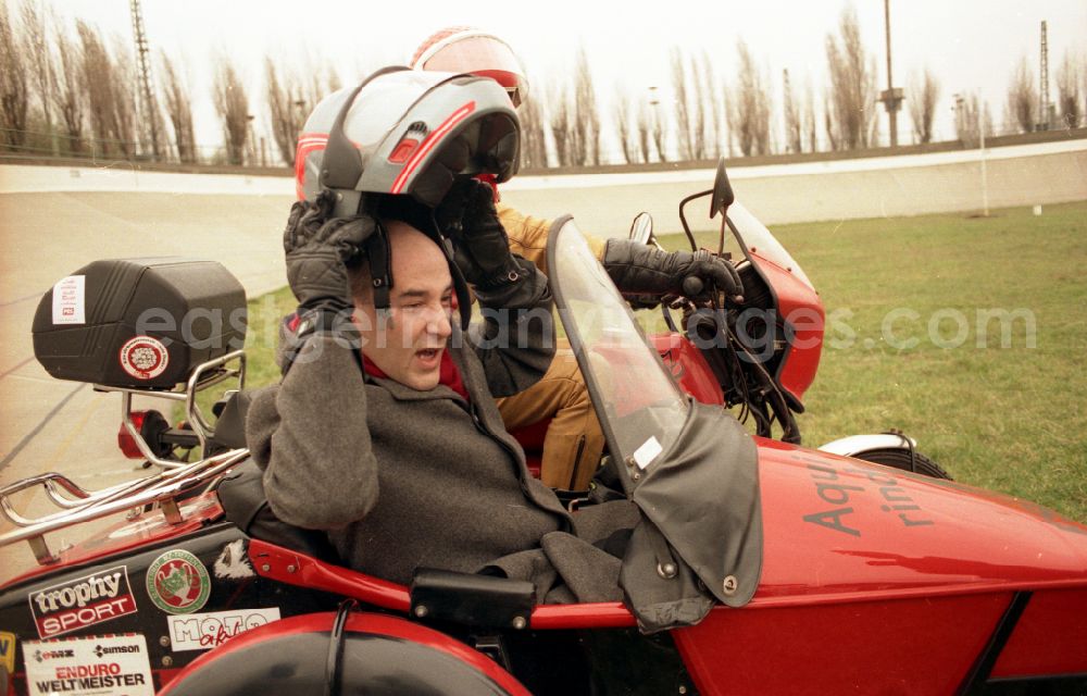 GDR photo archive: Berlin - PDS - left - politician Gregor Gysi drives to shooting for an election spot with the sidecar of an MZ - motorcycle on Rennbahnstrasse in the Weissensee district in Berlin East Berlin on the territory of the former GDR, German Democratic Republic