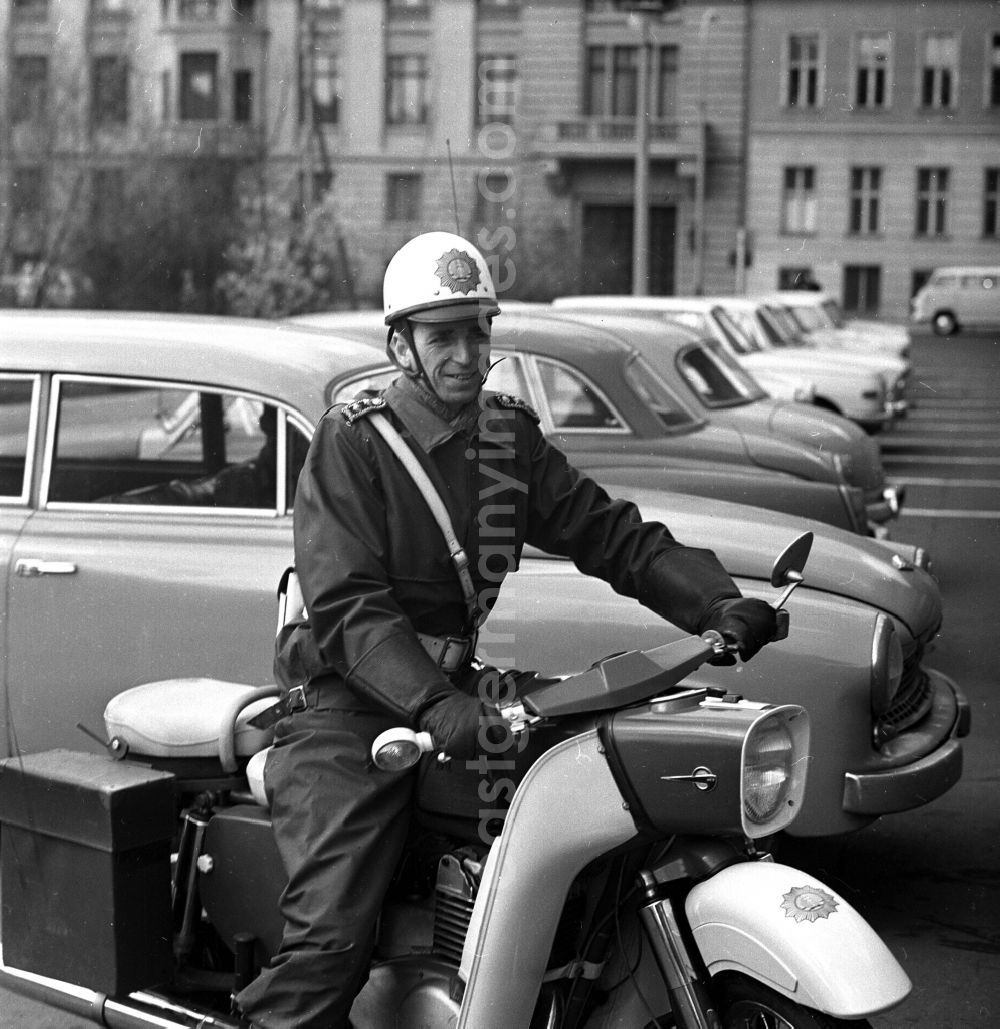 GDR image archive: Berlin - Police officer Meister der VP Eberhard Strumpf in uniform on a motorcycle MZ ES Trophy in the district of Friedrichshain in Berlin East Berlin on the territory of the former GDR, German Democratic Republic