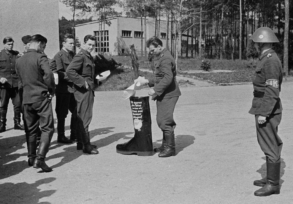 Dresden: Police officers in riot police uniform in the barracks yard with boots - slogan With our good deeds we will beat Straus and Adenauer on Koenigsbruecker Strasse in Dresden, Saxony on the territory of the former GDR, German Democratic Republic