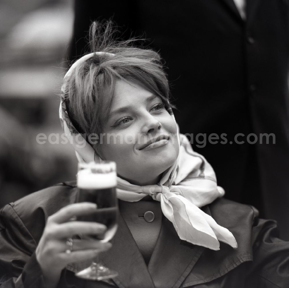 Berlin: Portrait Eva-Maria Hagen, actress holds a glass of beer in her hand, in Eastberlin on the territory of the former GDR, German Democratic Republic