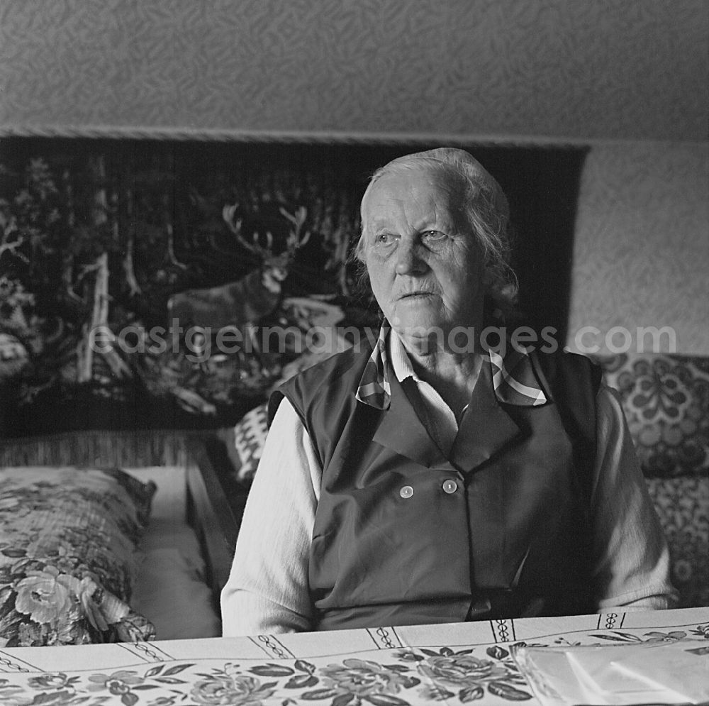 Burg (Spreewald): Portrait shot of an old Sorbian at the table in her living room in Burg (Spreewald), Brandenburg in the territory of the former GDR, German Democratic Republic
