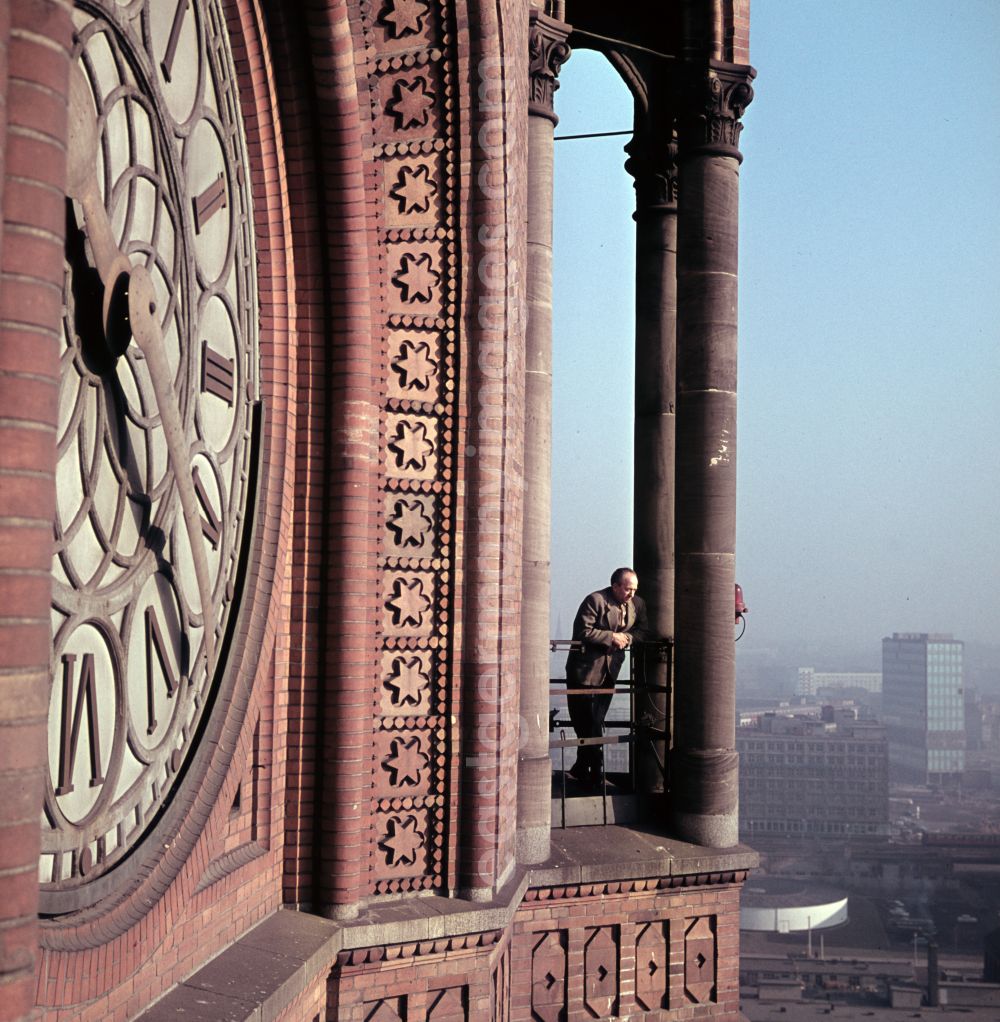 GDR image archive: Berlin - Man on the gallery of the tower at the building of the city hall of the city administration with the face of the tower clock of the Red City Hall in the district Mitte in Berlin East Berlin in the area of the former GDR, German Democratic Republic