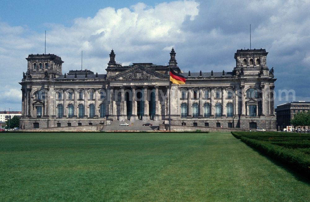 Berlin - Tiergarten: The Reichstag from Republic Square as seen with the waving flag of unity in Berlin - Mitte