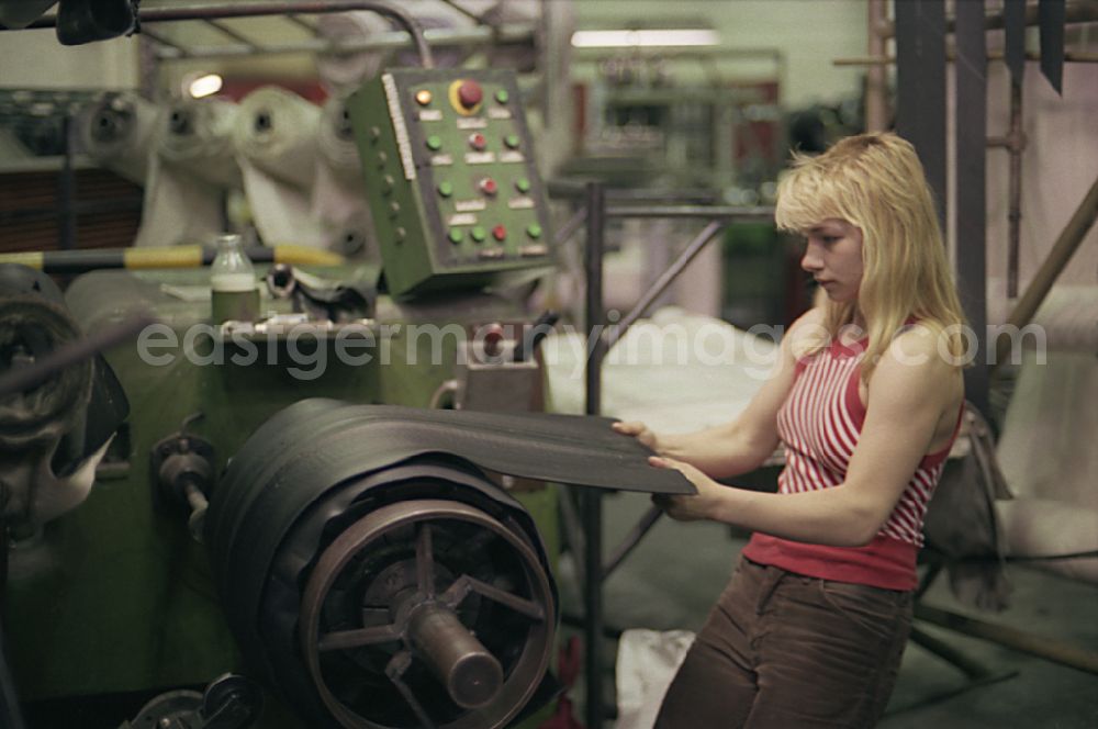 Neubrandenburg: Young woman as a worker at work and factory equipment for tire production in the VEB tire factory on Ihlenfelder Strasse in Neubrandenburg, of Mecklenburg-Western Pomerania on the territory of the former GDR, German democratic republic