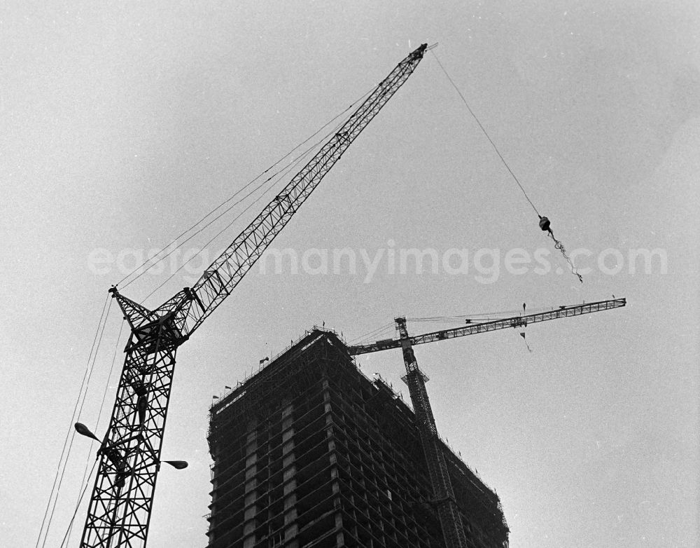 GDR photo archive: Berlin - Raising the topping-out wreath for the topping-out ceremony of the construction site Interhotel Stadt Berlin (later also FORUM HOTEL and today Park Inn by Radisson) at Alexanderplatz in the Mitte district of Berlin East Berlin on the territory of the former GDR, German Democratic Republic