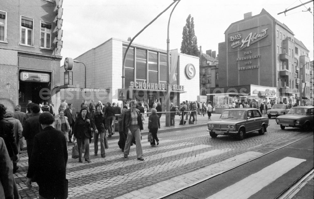GDR image archive: Berlin - Car - motor vehicle of the type Lada and Wartburg in traffic waiting in front of a pedestrian crossing in Berlin East Berlin on the territory of the former GDR, German Democratic Republic. In the background, the Schoenhauers Allee S-Bahn station