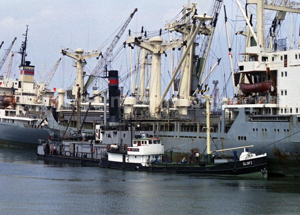 GDR photo archive: Rostock - Loading, supply and unloading of ships the DSR in the overseas port at the quays in the port area in Rostock in the state Mecklenburg-Western Pomerania on the territory of the former GDR, German Democratic Republic