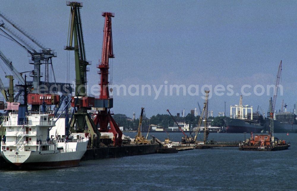 GDR photo archive: Rostock - Loading, supply and unloading of ships VEB Deutfracht - Seereederei Rostock DSR at the quays in the port area in Rostock in the state Mecklenburg-Western Pomerania on the territory of the former GDR, German Democratic Republic