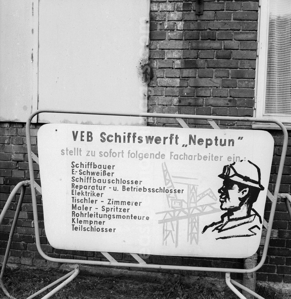 GDR photo archive: Rostock - Sign of the dockyard VEB Neptune about open jobs in Rostock in the federal state Mecklenburg-West Pomerania in the area of the former GDR, German democratic republic. Searched to the immediate setting in the production skilled workers become welders, shipbuilding locksmiths, repair and company locksmiths, electricians, joiners - carpenter, painter - splash, conduit assemblers, plumbers and part locksmiths as a shipwright