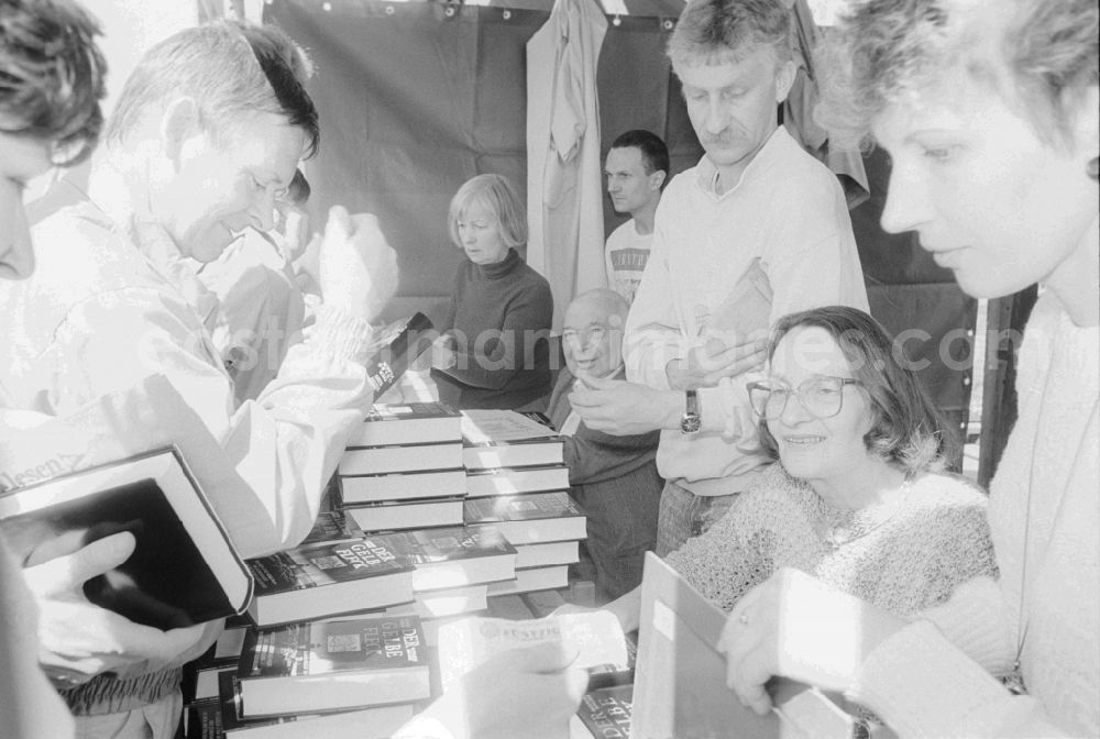 GDR picture archive: Berlin - Cultural supply of creators of literatur and theater at the fair for public entertainment during the 1st of may at the Alexanderplatz in Berlin in Germany. Author Rosemarie Schuder signing her book Der gelbe Fleck at a bazaar