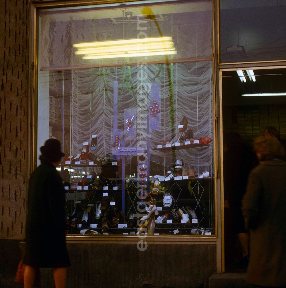 Berlin: A woman looks to herself the new spring collection in the shop-window of a shoe store in in Berlin, the former capital of the GDR, German democratic republic