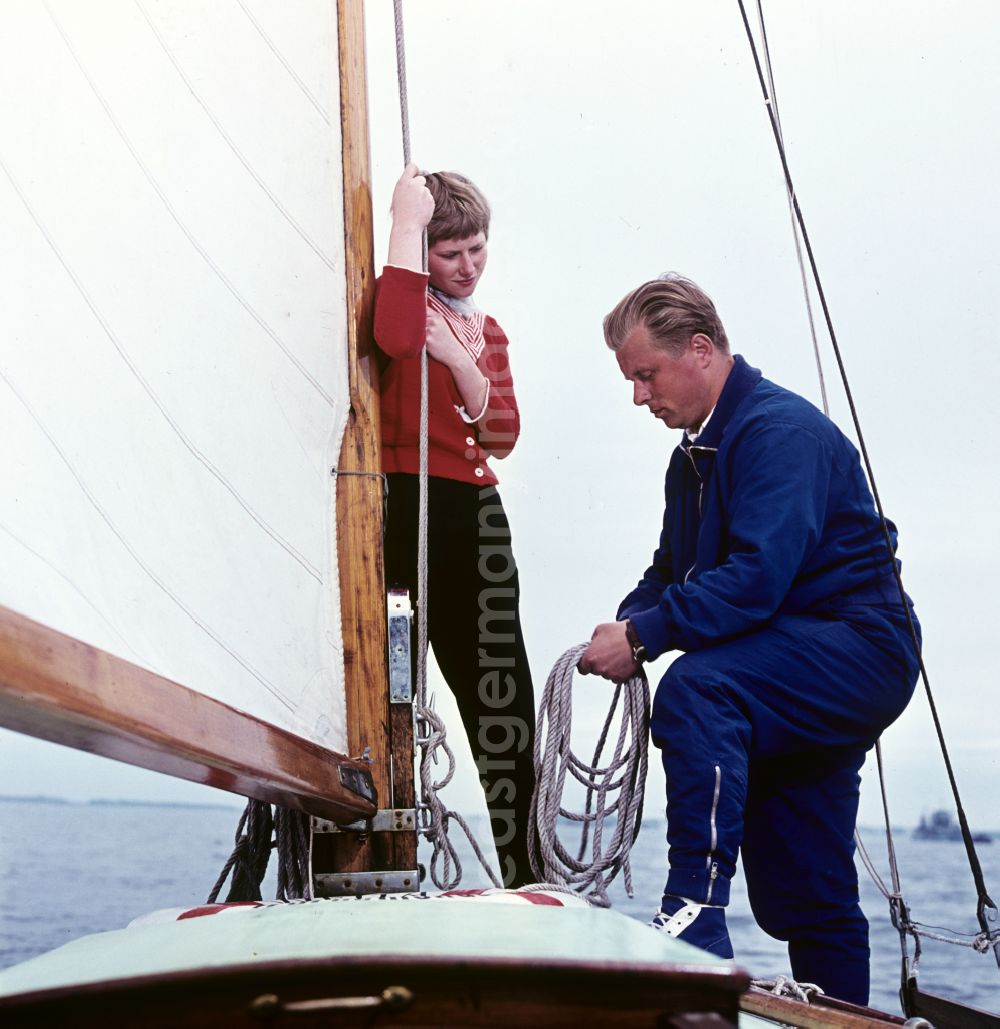 Rostock: Young couple sailing on the Baltic Sea near Rostock, Mecklenburg-Western Pomerania in the territory of the former GDR, German Democratic Republic