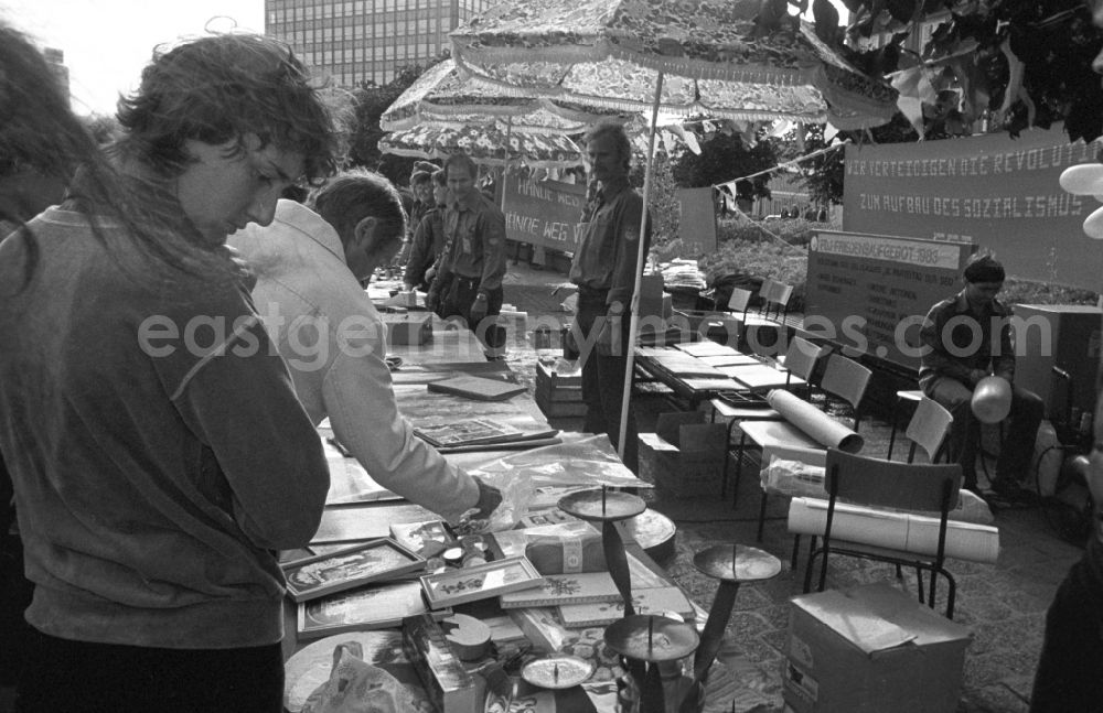 GDR photo archive: Berlin - FDJers of the 1983 Peace Rally hold their solidarity bazaar on Alexanderplatz in Berlin, the former capital of the GDR, German Democratic Republic, under the slogan: We defend the revolution to build socialism.