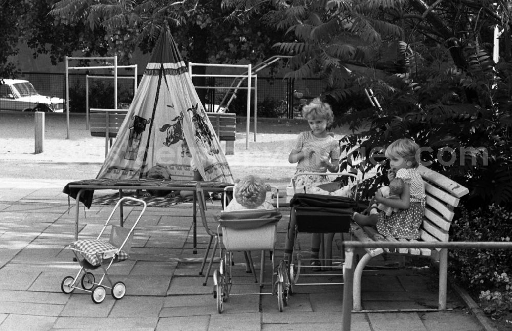 GDR image archive: Berlin - Summer temperatures while playing and having fun with toddlers cared for by educators in a kindergarten on a playground in Berlin East Berlin on the territory of the former GDR, German Democratic Republic