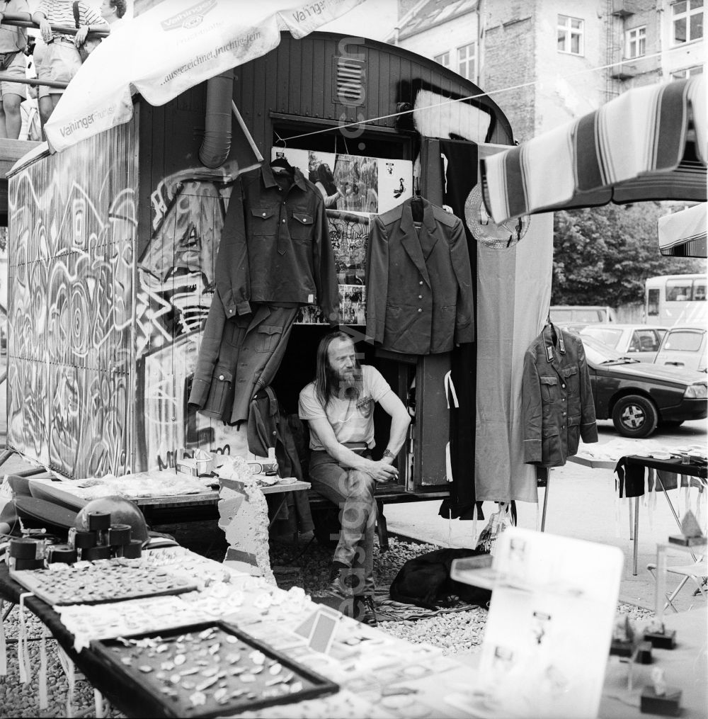 GDR photo archive: Berlin - Souvenir dealers with GDR uniform parts, badges and effects at Allied Checkpoint Charlie on Friedrichstrasse in the Kreuzberg district of Berlin