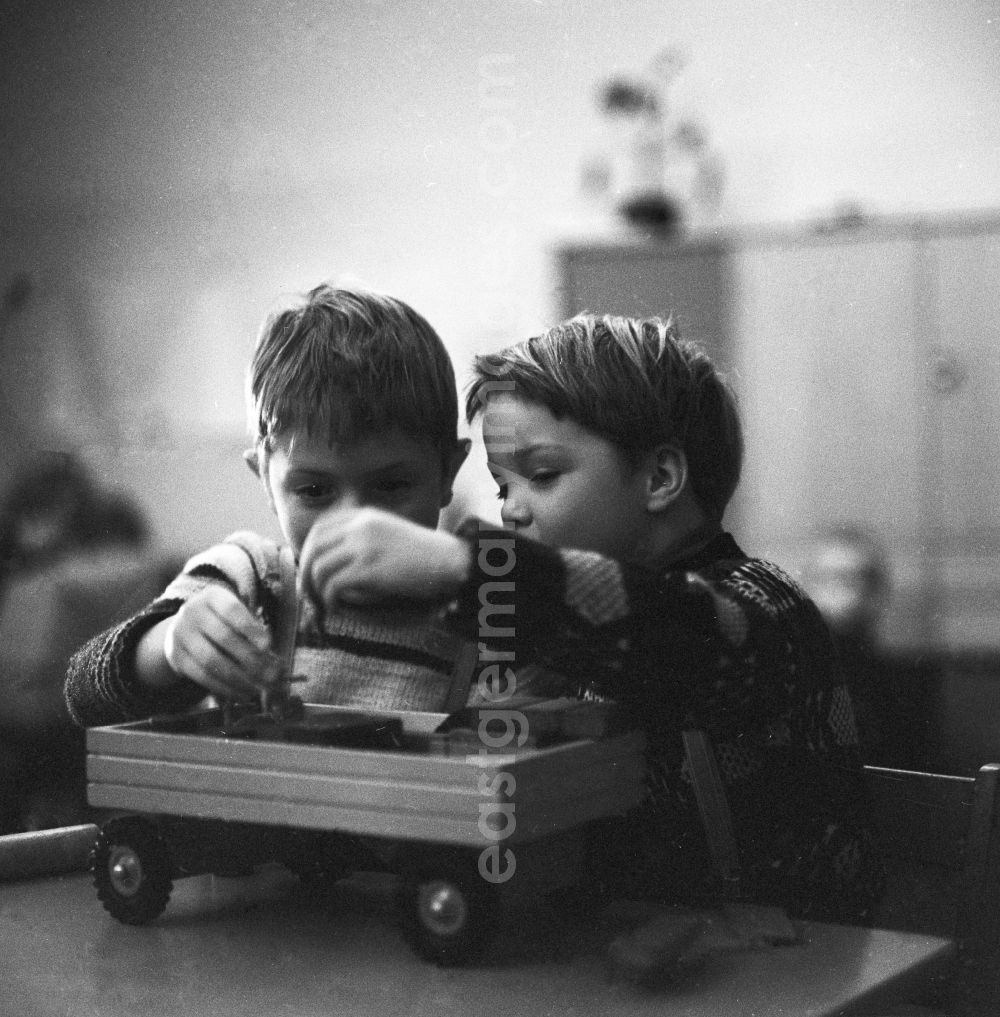 GDR photo archive: Berlin - Children playing with a wooden toy in Berlin