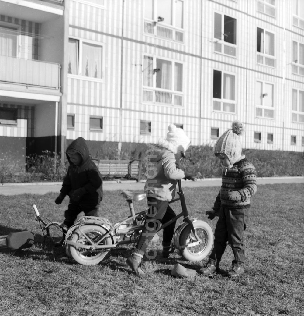 Berlin: Children playing with their pneumatic scooters in a courtyard of a residential area in Berlin, the former capital of the GDR, German Democratic Republic