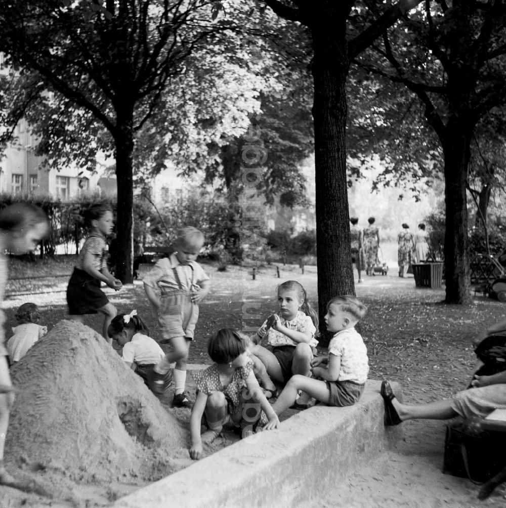 GDR photo archive: Berlin - The playing children in the sandpit who build a sand castle, in Berlin, the former capital of the GDR, German democratic republic