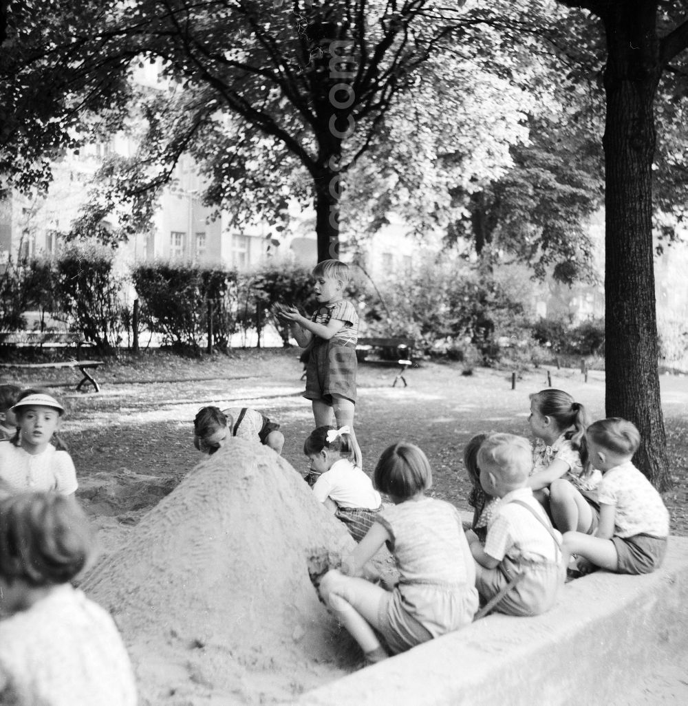 GDR picture archive: Berlin - The playing children in the sandpit who build a sand castle, in Berlin, the former capital of the GDR, German democratic republic