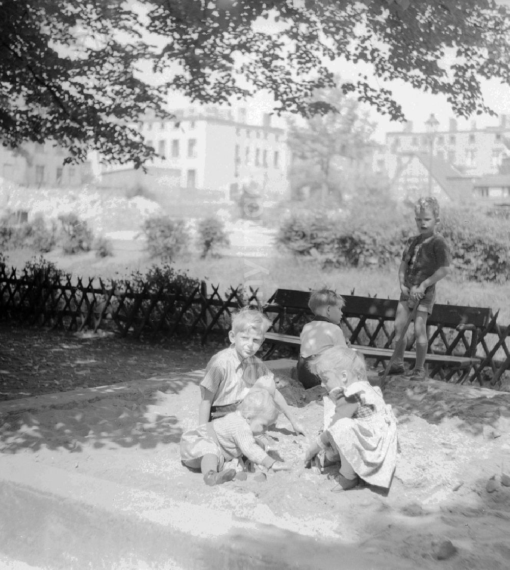GDR photo archive: Berlin - The playing children in the sandpit who build a sand castle, in Berlin, the former capital of the GDR, German democratic republic