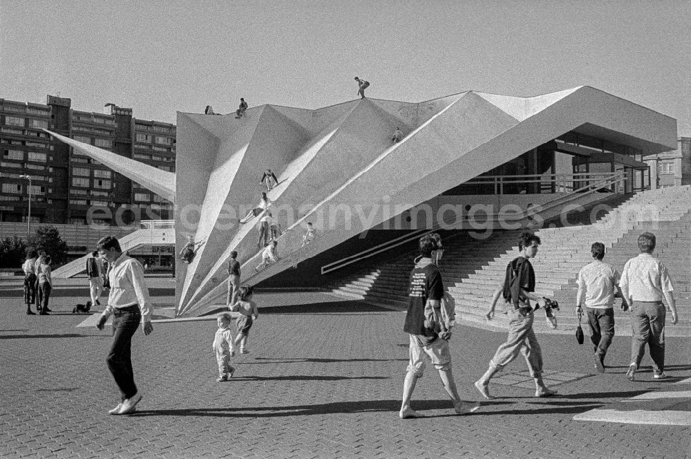 GDR picture archive: Berlin - Children and young people playing and climbing on the facade elements of contemporary architecture of the television tower folds on Panoramastrasse in the Mitte district of Berlin East Berlin in the area of the former GDR, German Democratic Republic