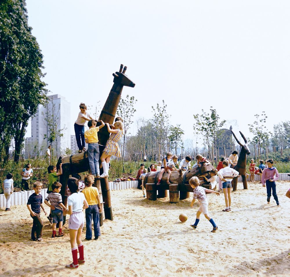 GDR image archive: Berlin - Children play on playground equipment such as giraffe, hippo and ibex at the playground in the residential area and park area Ernst-Thaelmann-Park Prenzlauer Berg in Berlin Eastberlin on the territory of the former GDR, German Democratic Republic