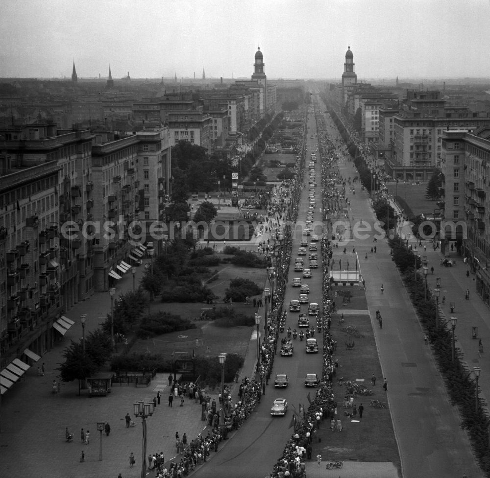 GDR image archive: Berlin - State visit of the Soviet Prime Minister Nikita Khrushchev to Berlin in the territory of the former GDR, German Democratic Republic. Nikita Khrushchev and Walter Ulbricht drive together past spectators along Stalinallee, now Karl-Marx-Allee. The towers at Frankfurter Tor in the background