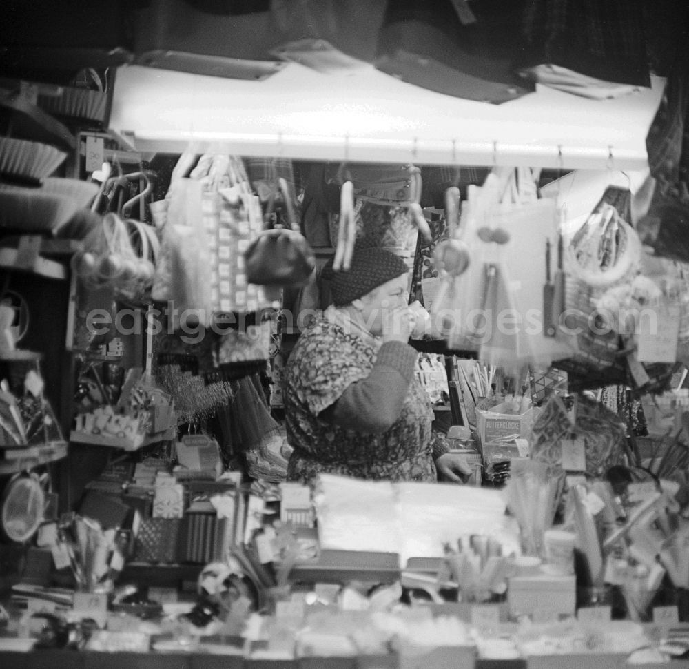 GDR photo archive: Berlin - Saleswoman and her status for household goods in the market hall on Alexanderplatz in Berlin, the former capital of the GDR, the German Democratic Republic