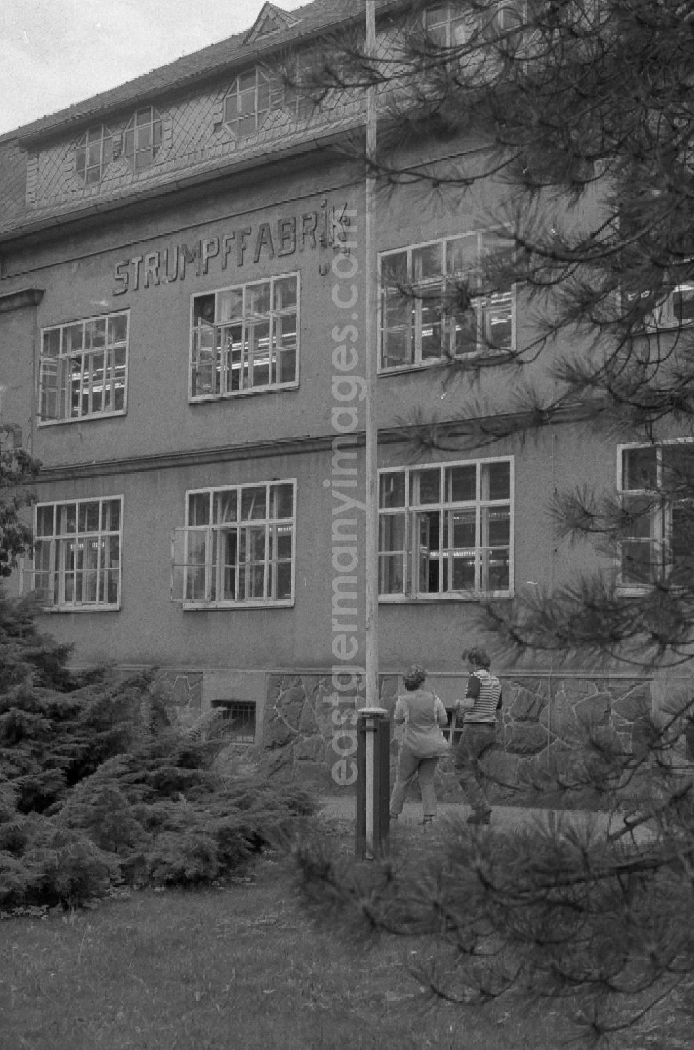 Thalheim: Outside - facade of the women's company of the stocking factory for the production of nylon - women's stockings as VEB fine stockings Esda in Thalheim in the Ore Mountains in the state of Saxony on the territory of the former GDR, German Democratic Republic