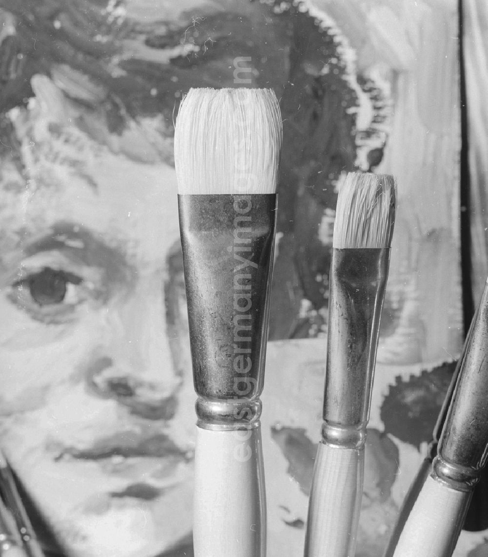GDR image archive: Berlin - Symbolic picture - sign paintbrush before a portrait in Berlin, the former capital of the GDR, German democratic republic