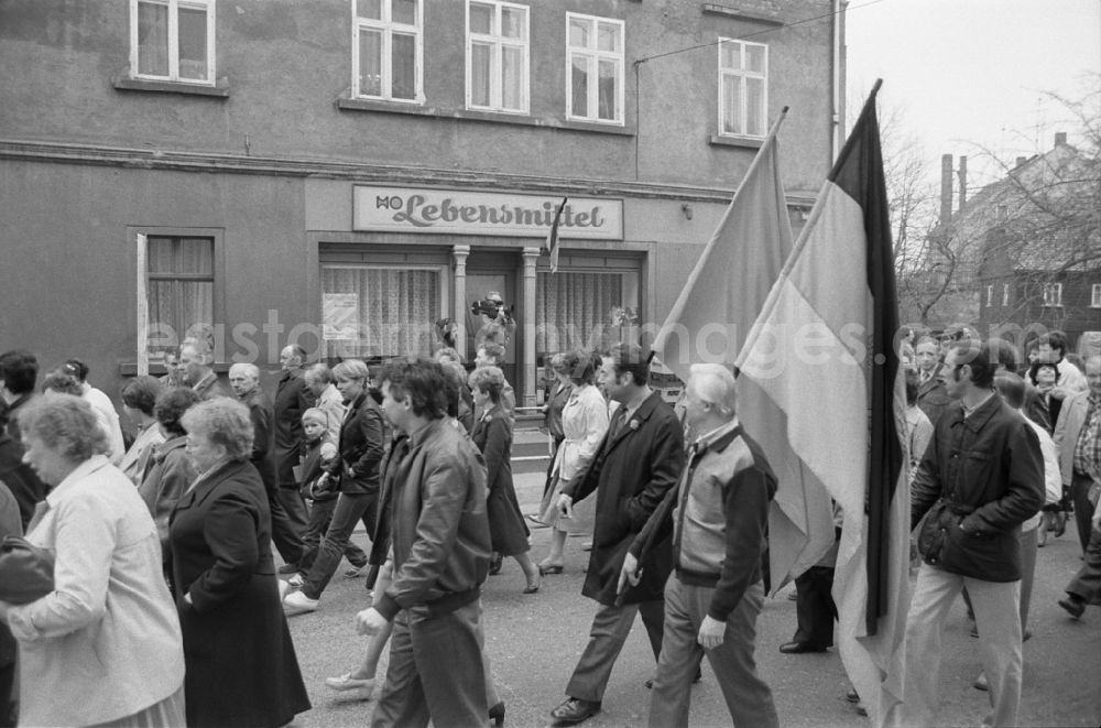 GDR photo archive: Ebersbach - Participants of the May Day event with flags in Ebersbach in GDR