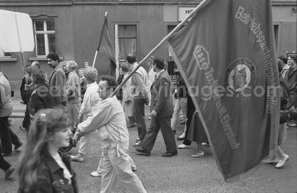 GDR picture archive: Ebersbach - Participants of the May Day event with flags in Ebersbach in GDR