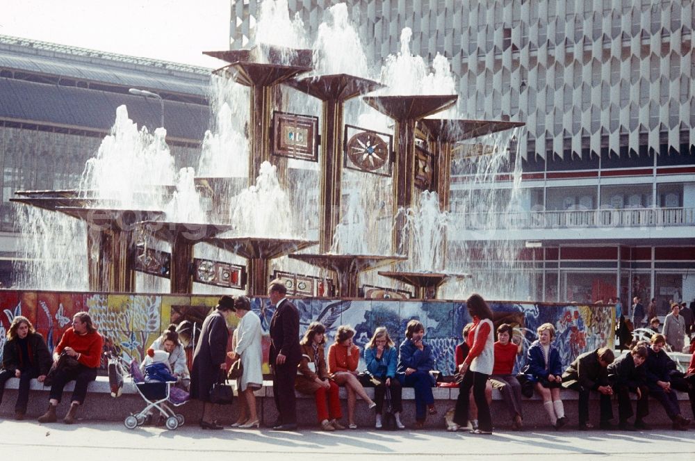 Berlin: Tourists in front of the Fountain of International Friendship in Alexanderplatz in Berlin, the former capital of the GDR, German Democratic Republic. The fountain designed Walter Womacka under the redesign of Alexanderplatz